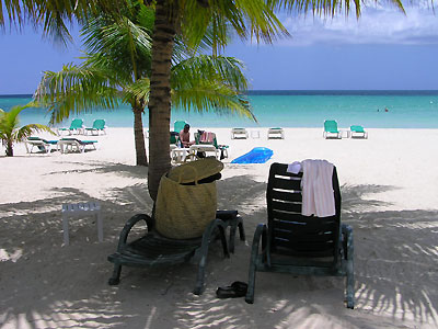 Charela Beach Magestic palms line Charela's beach and offer a cool place to chill out and watch the world go by. Lounges and beach towels provided. - Charela Inn Beach - Negril Resorts and Hotels, Jamaica